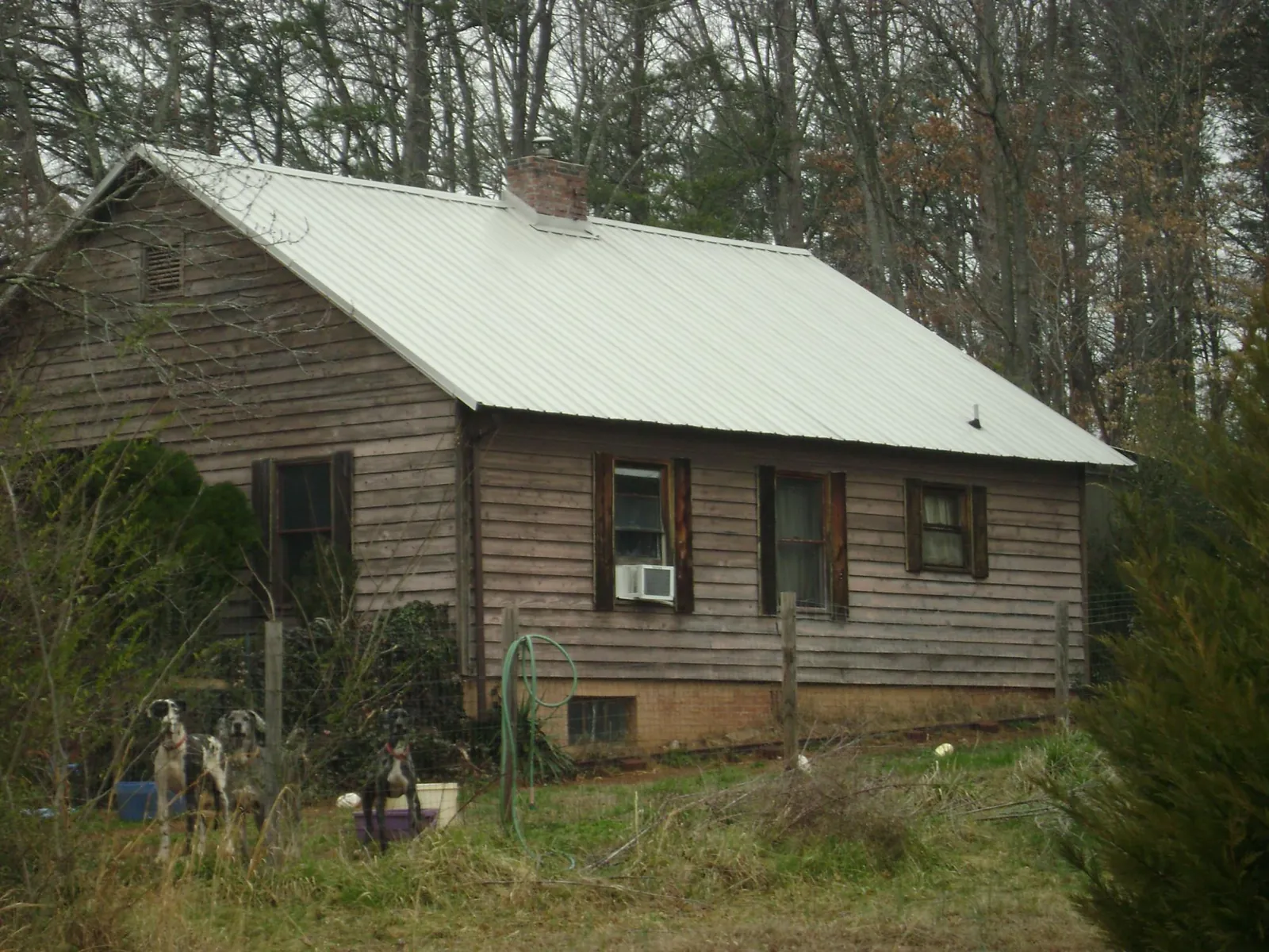White metal roof on an old wood sided farmhouse, from a Metal Roof Installation job in Savannah